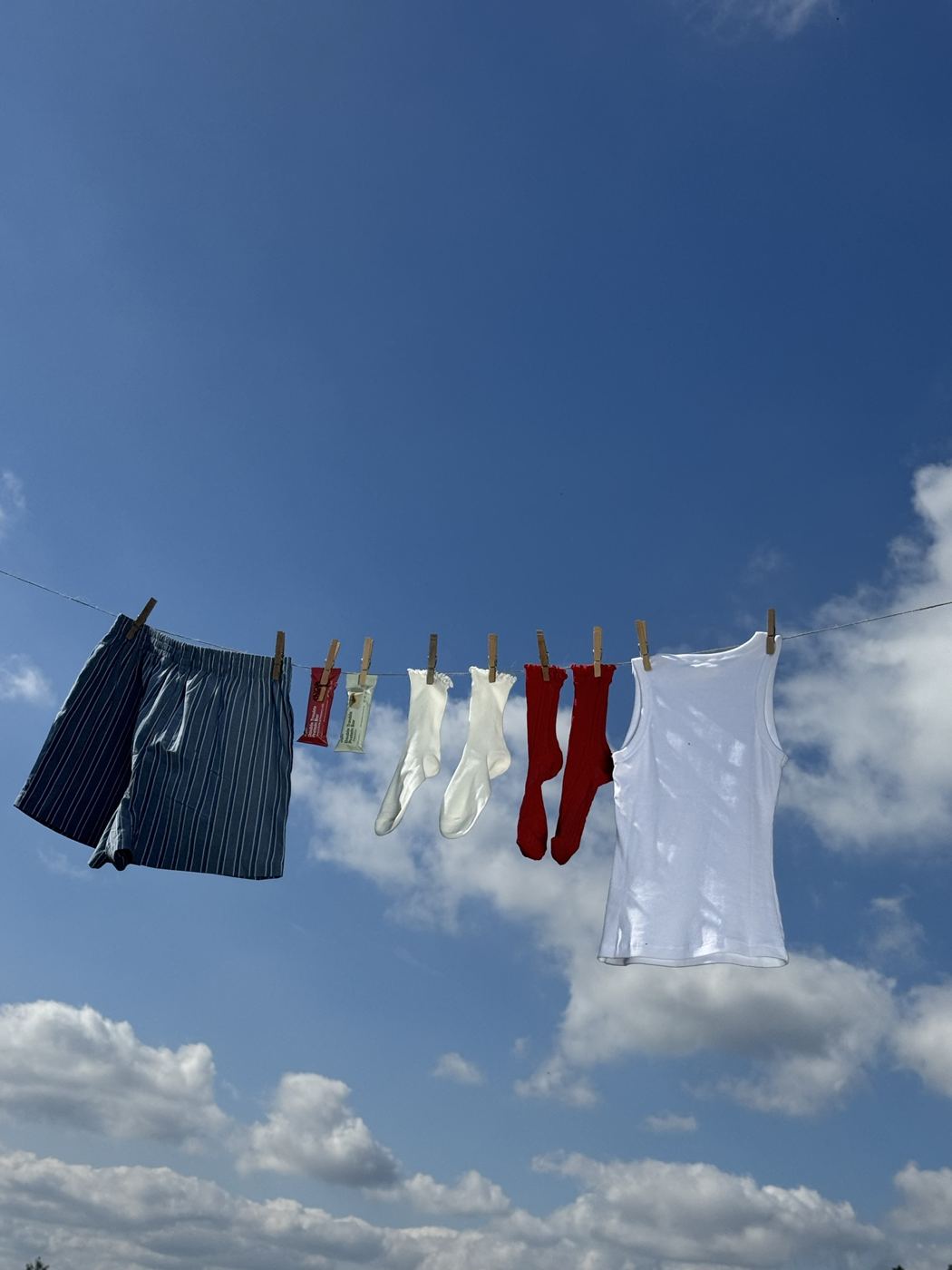 Clothes drying on a line against a blue sky