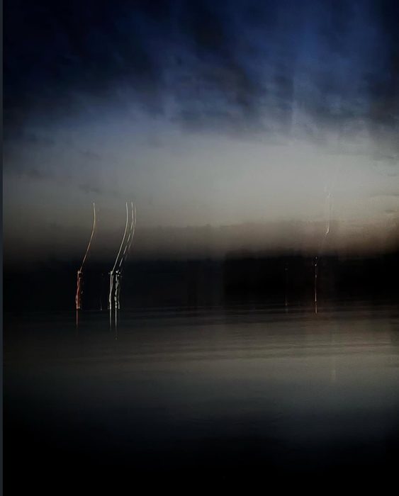 Long exposure of lights over dark water