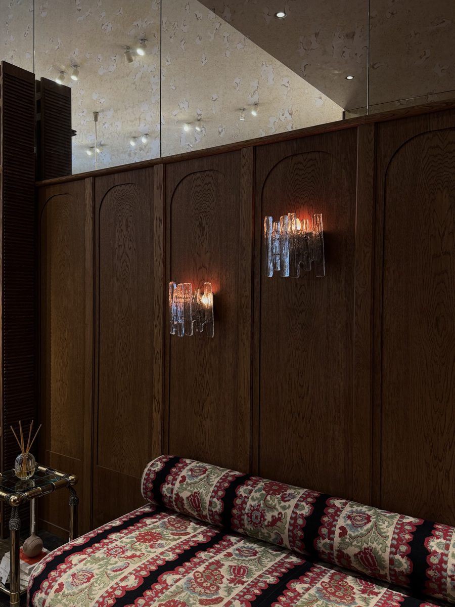 Ice-glass sconces on dark wood panelling