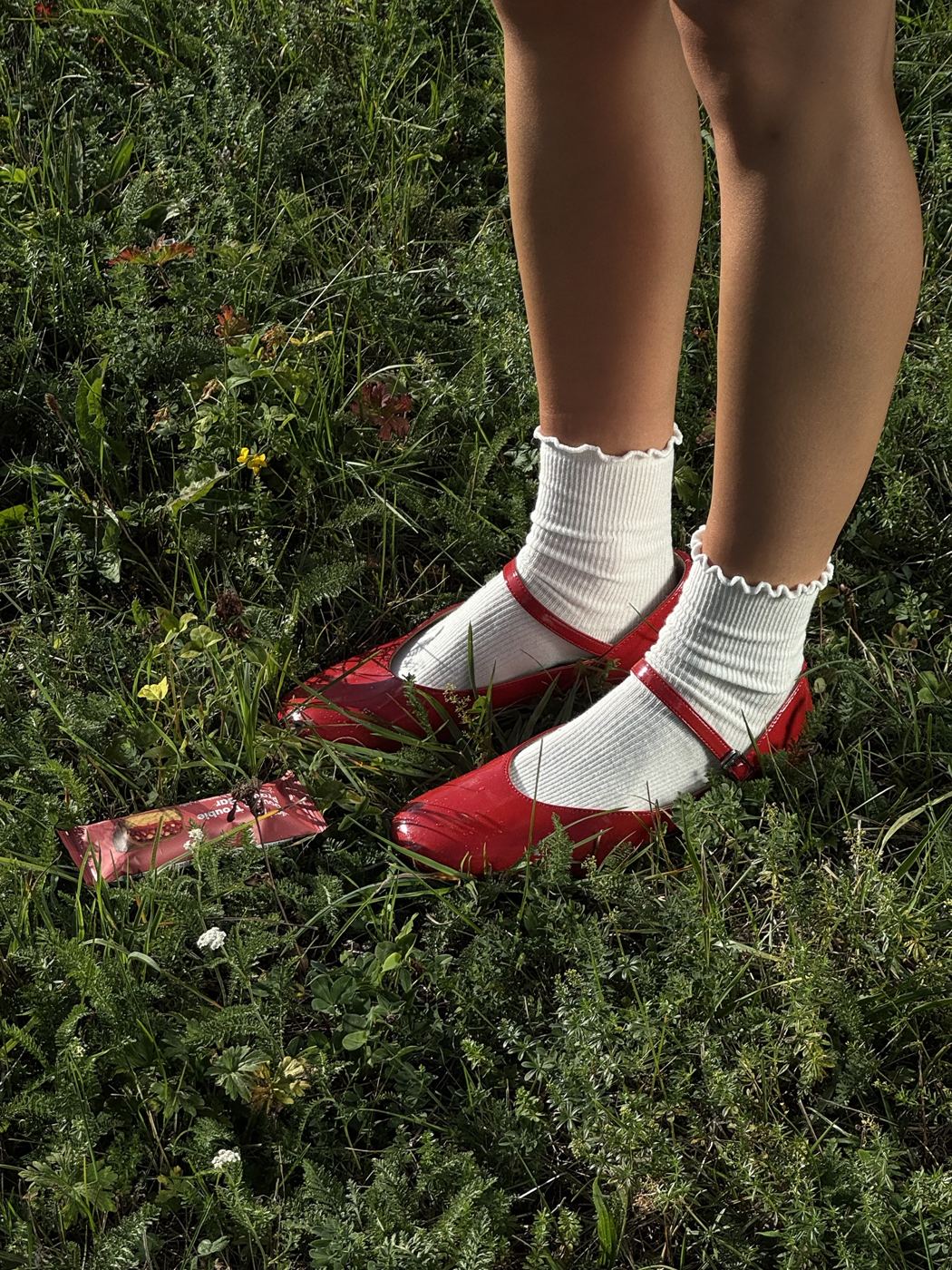 Red shoes and white socks on the grass