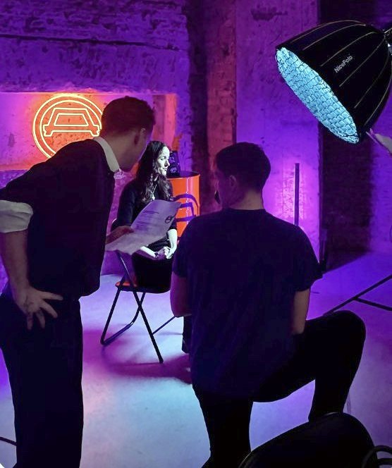 Behind the scenes on a purple-lit interview set I produced